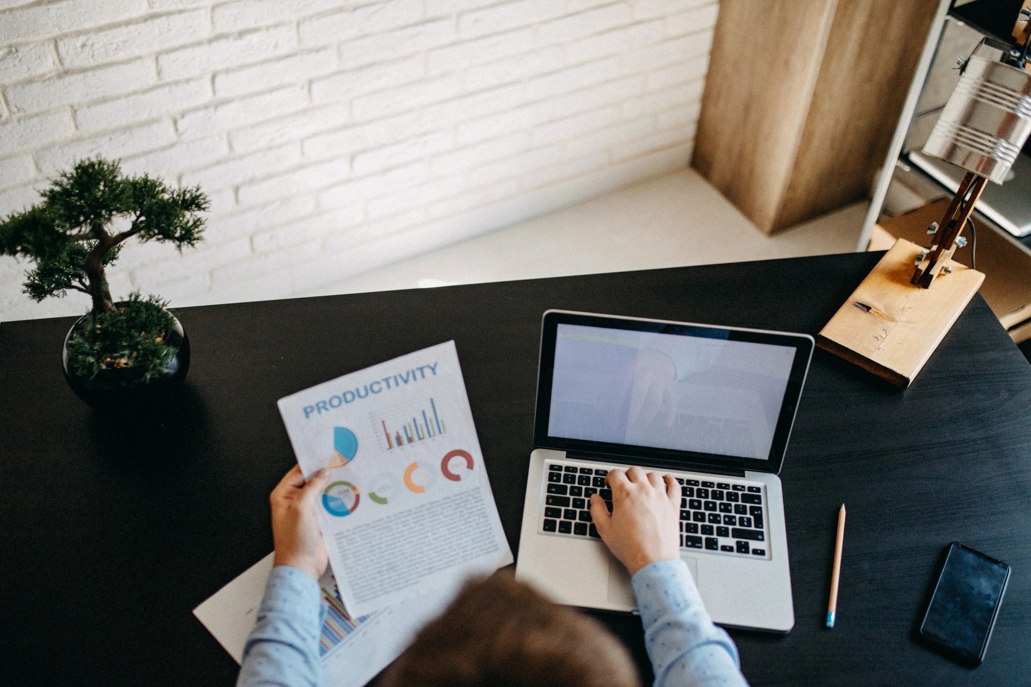 Professional working with financial reports and laptop